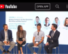 Panelists on stage with YouTube content displayed.